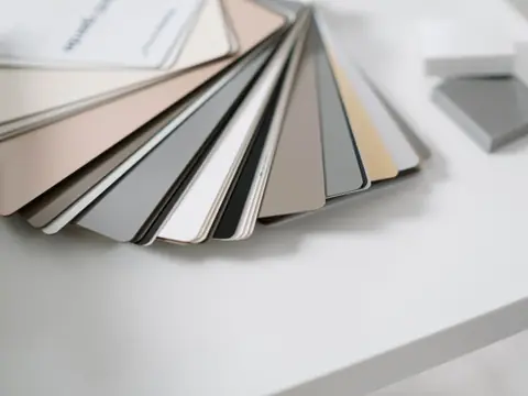 A fan of color samples on a white desk