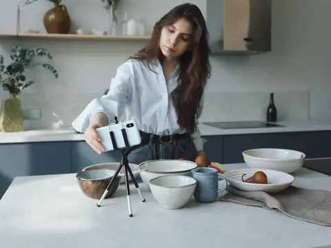 Setting up a phone on a small tripod on a kitchen counter