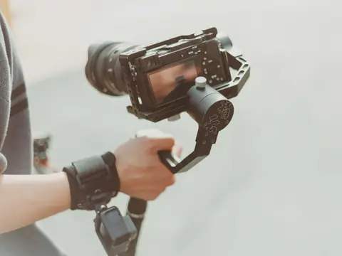 A camera on a hand-held stabilizer